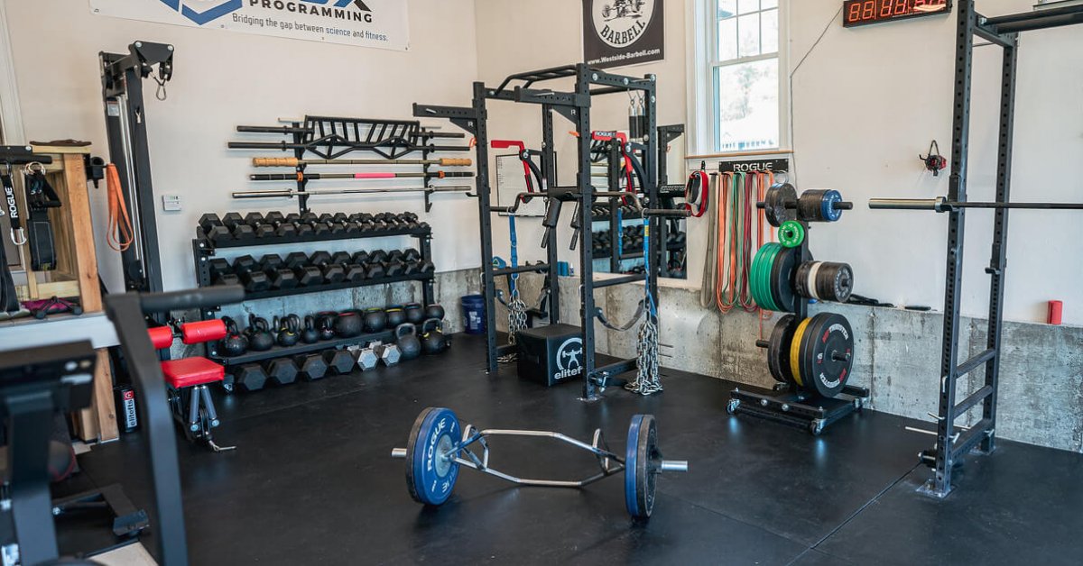 home gym with power rack, hex dumbbells, and trap bar